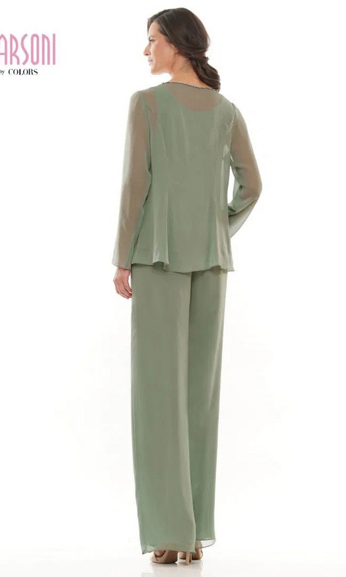 A woman faces away in a light sage green Marsoni M304 long formal pantsuit, featuring wide-leg chiffon pants and a long-sleeve top, standing against a plain white background.